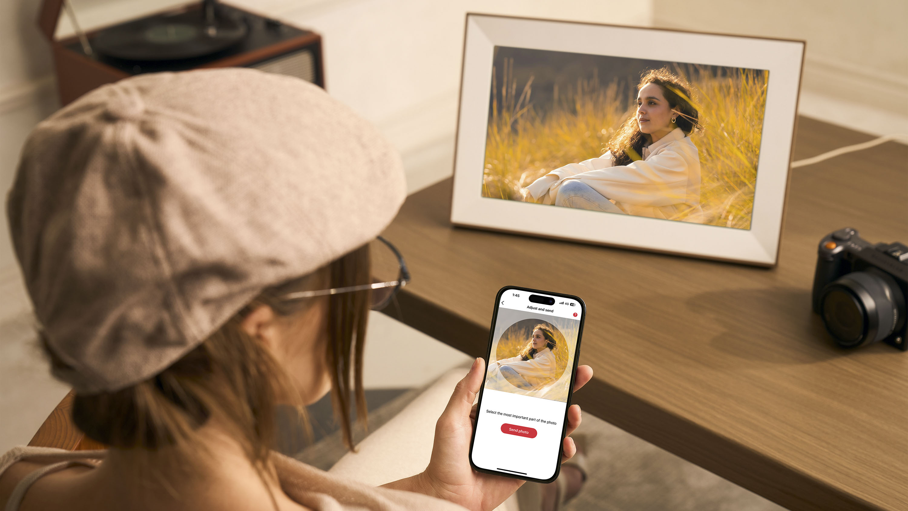 Pexar Starlight digital photo frame on a coffee table, with user changing the display on the companion app