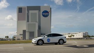 NASA astronauts Bob Behnken and Doug Hurley walk out of NASA's Astronaut Crew Quarters and take a Tesla Model X to Launch Pad 39A during a dry-run test of their SpaceX Crew Dragon Demo-2 flight on May 23, 2020 at the Kennedy Space Center in Florida.