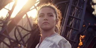 Yelena Belova (Florence Pugh) stands in front of burning wreckage in 'Black Widow'