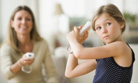 A mother and daughter play a Wii video game: Active video games, like Nintendo&amp;#039;s Wii, don&amp;#039;t actually encourage kids to move more than sedentary ones. 