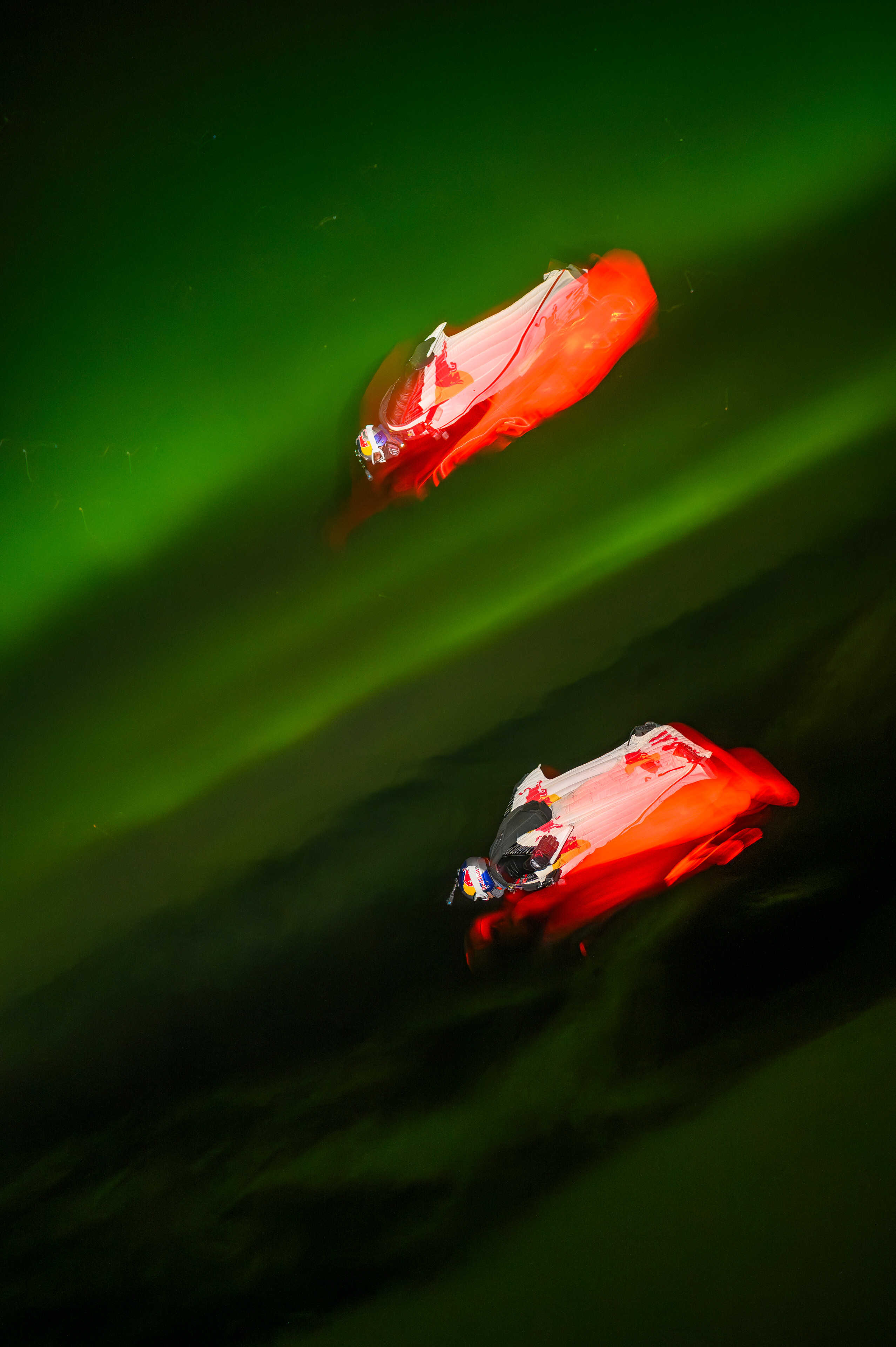 Jeff Provenzano and Jon DeVore wingsuit skydiving under the Aurora Borealis near Palmer, Alaska on March 23, 2026.