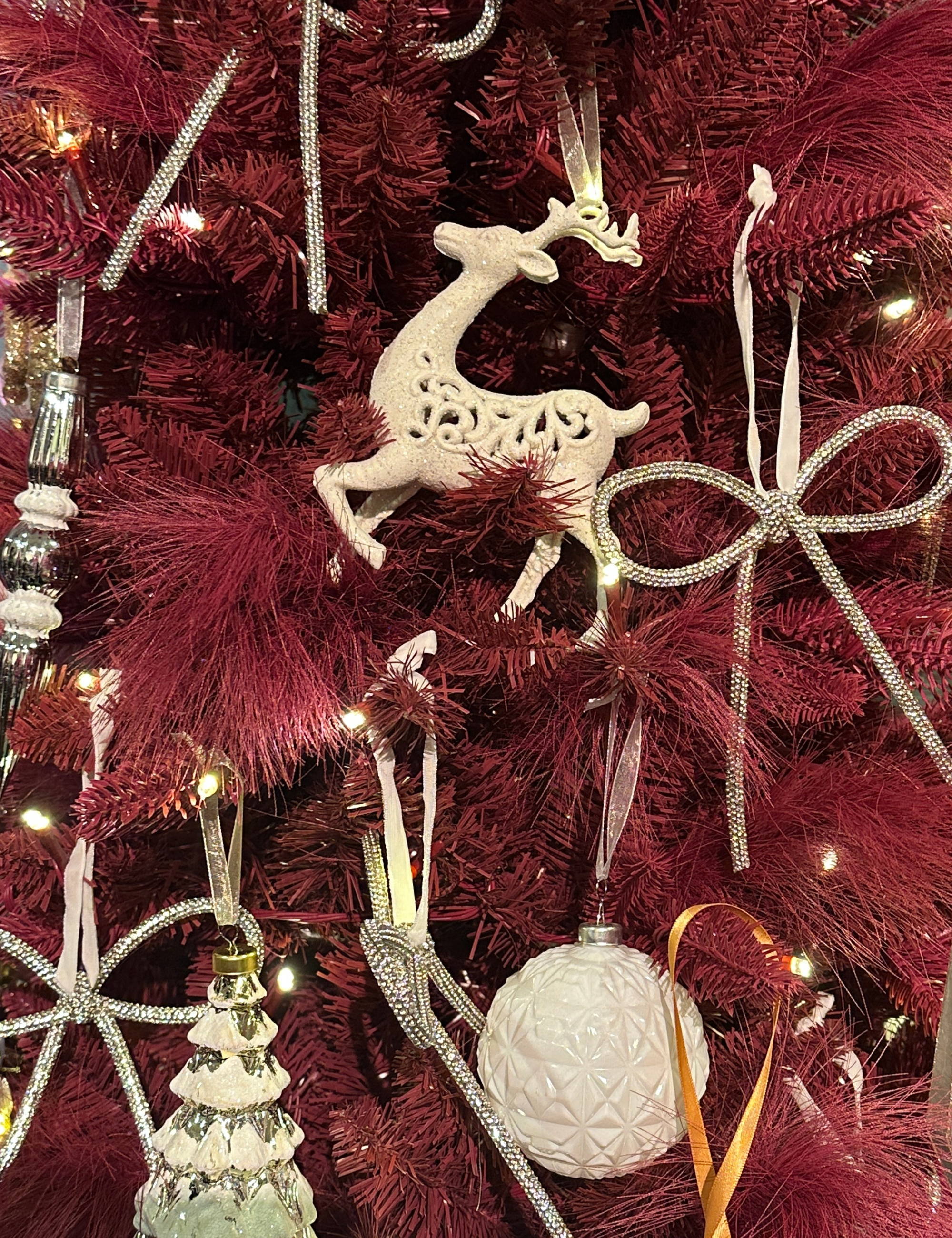 Pink QVC Christmas tree decorated with flocked ornaments and white LED string lights