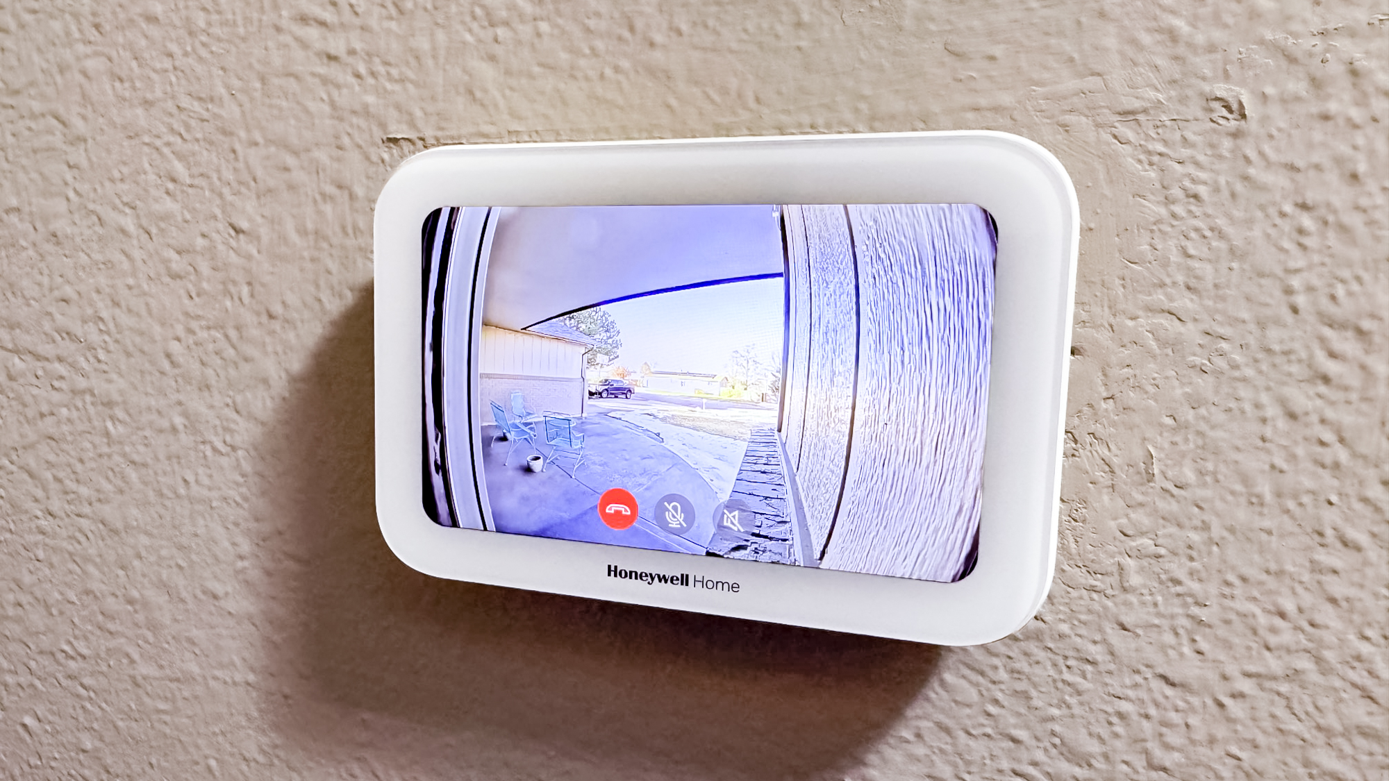 Honeywell Home X8S Smart Thermostat mounted to a hallway wall