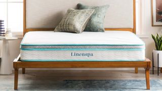 Linenspa Memory Foam Hybrid Mattress featured on a wood bed frame with decorative pillows on top