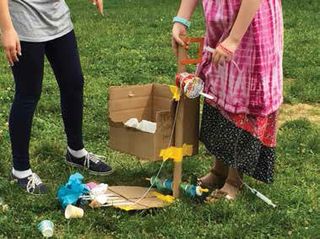 BCPS fourth-graders test the trash-collecting devices they designed so that P.E. teachers can hold classes outside. 