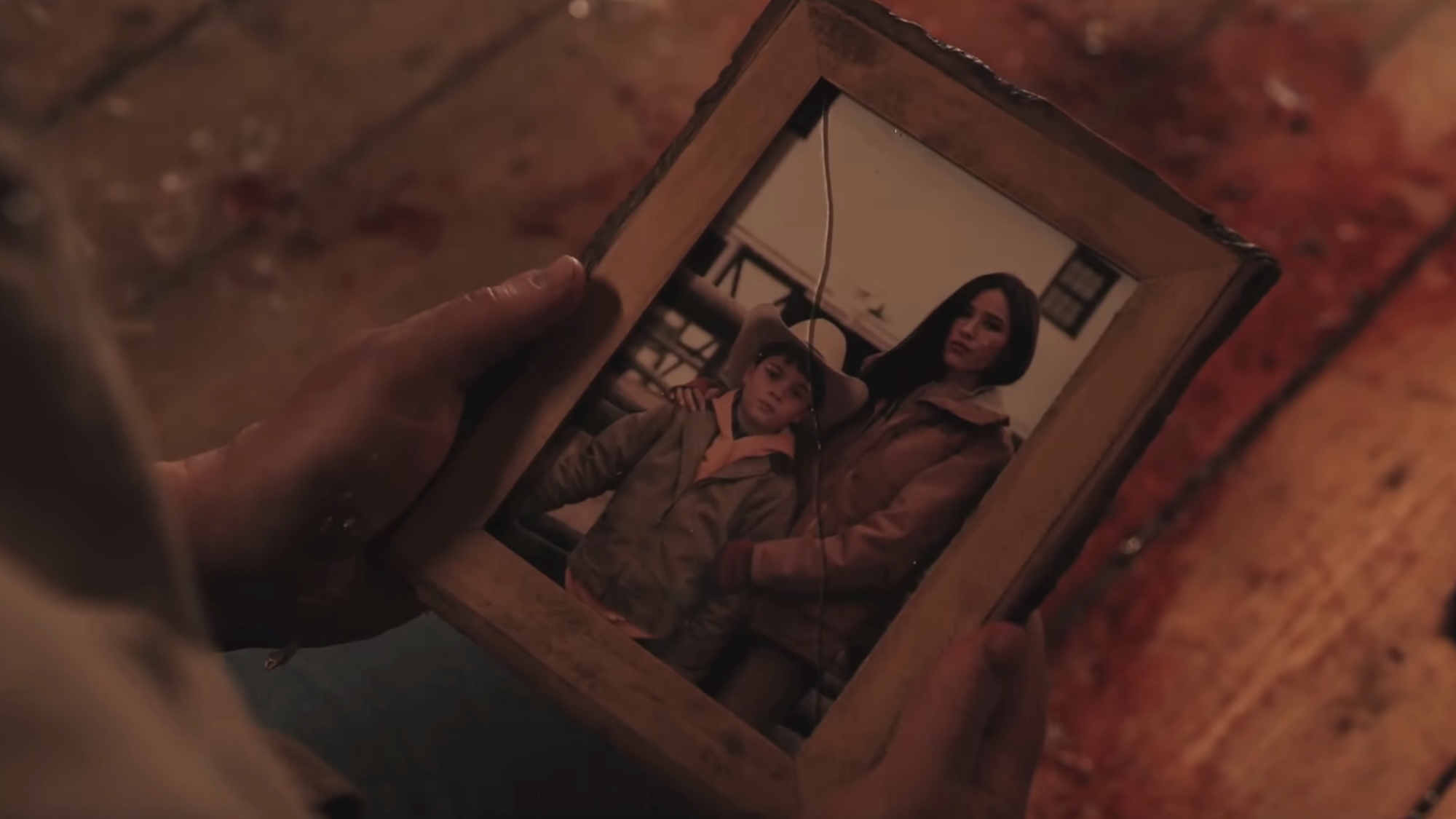 Close-up of photo of Tate and Monica in a broken frame in Marshals Season 2