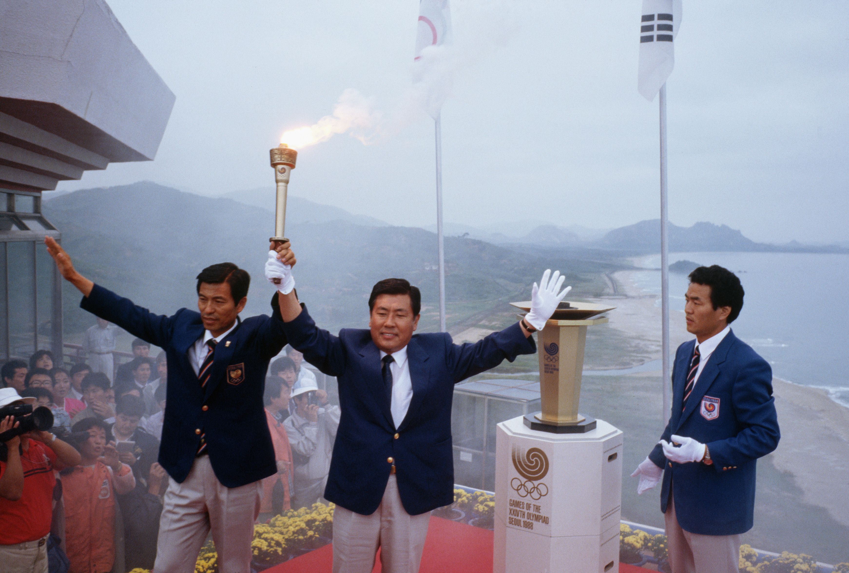 Korean Olympic officials raise the Olympic torch before lighting the Olympic flame during opening ceremonies for the 1988 Summer Olympic Games in Seoul.