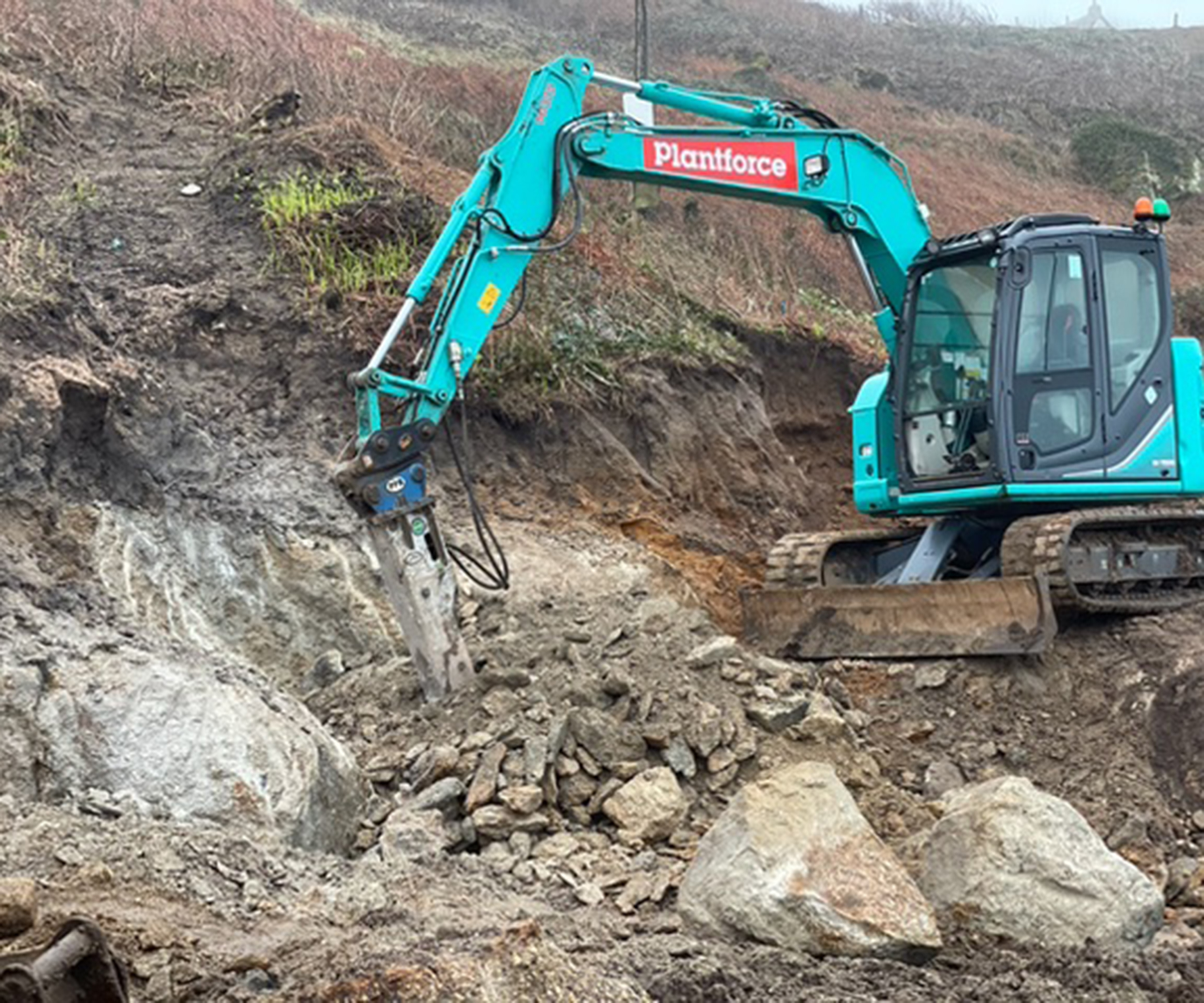 A digger taking out the side of a cliff to make room for a new self build home