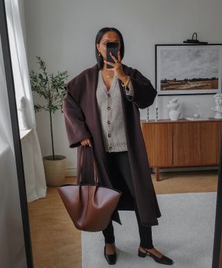 Influencer wears a burgundy coat.