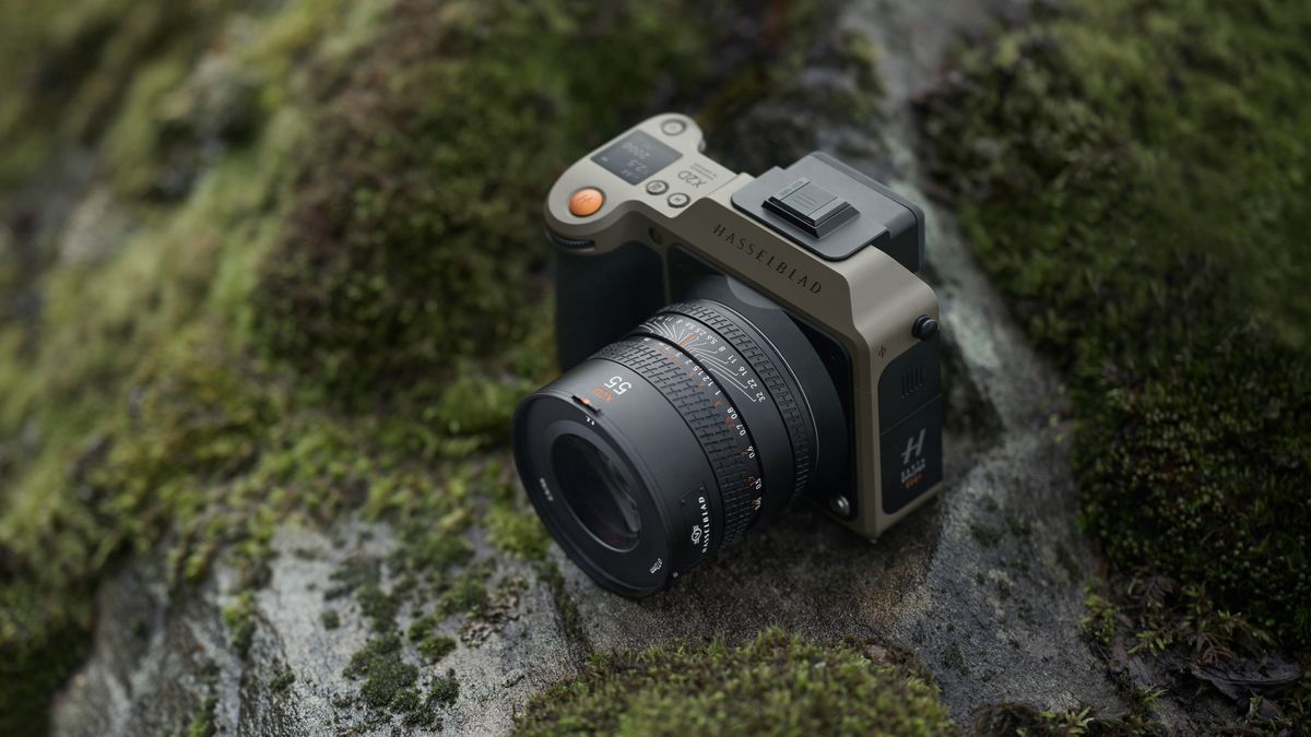 The Hasselblad X2D 100C Earth Explorer Edition camera and lens sitting on a mossy, rocky outcrop