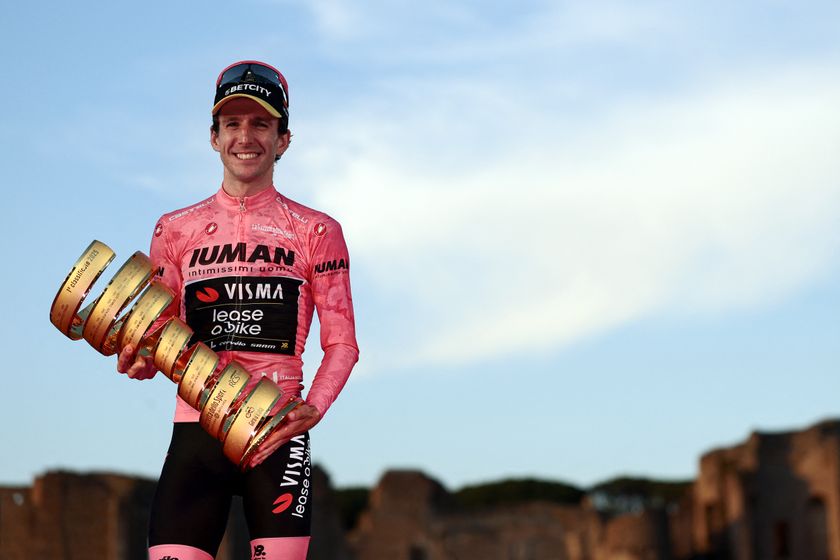 Team Visma-Lease a Bike&#039;s British rider Simon Yates wearing the pink jersey of overall leader (Maglia Rosa) celebrates holding the Trofeo Senza Fine on the podium after the 21st and last stage and winning the 108th Giro d&#039;Italia cycling race of 143kms from Rome to Rome on June 1, 2025. (Photo by Luca Bettini / AFP) (Photo by LUCA BETTINI/AFP via Getty Images)