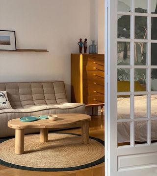 Living room with neutral couch and round jute rug