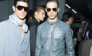 2 male models pose for the camera in sunglasses