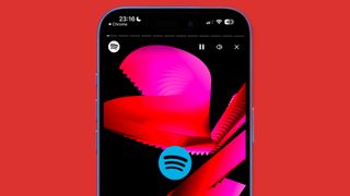 An iPhone on a red background showing Spotify Wrapped 2024 appearing in a web player