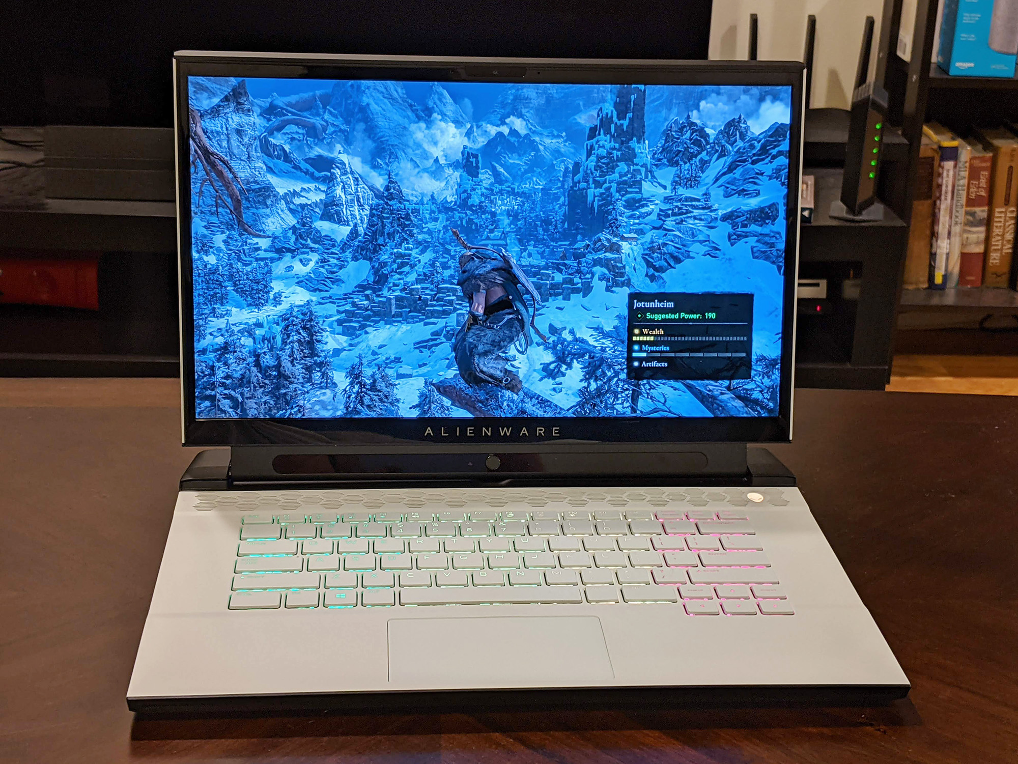 Alienware m15 R4 2021 open on a desk showing Windows background