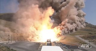 This still from an ATK webcast shows a top-down view of the five-segment solid rocket booster DM3 during a Sept. 8, 2011 static test firing at the company's motor proving grounds near Promontory, Utah.