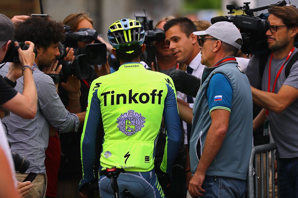 Reporters surround Alberto Contador after the finish of Dauphine's fifth stage