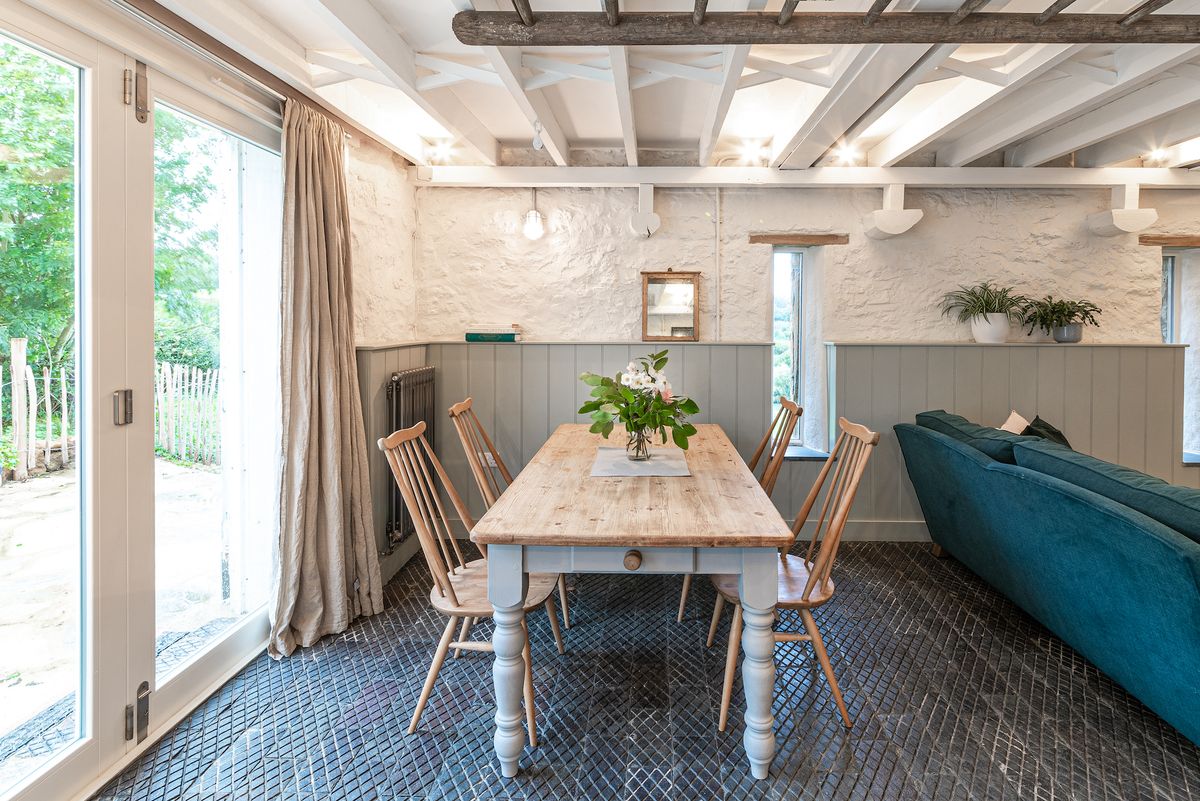 dining room with stone walls and wood panelling