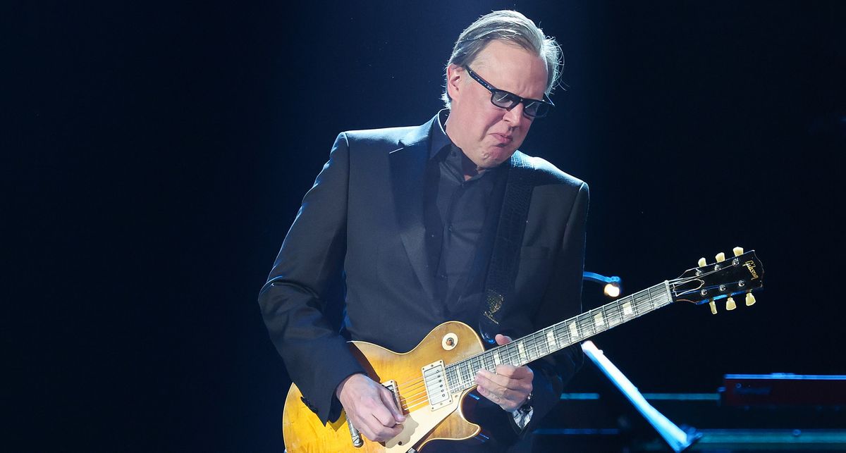 Joe Bonamassa plays a Gibson Les Paul Standard at the Grammys. He wears a dark suit, dark shirt and shades.