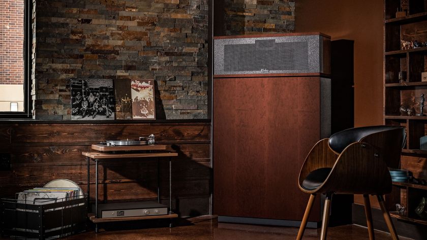 Klipsch Klipschorn AK7 in a room with lots of dark wood furniture and a bare brick wall