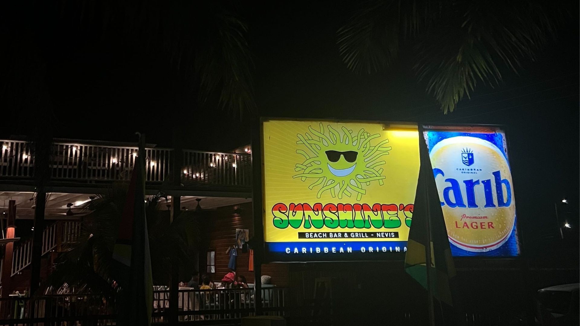 View of the brightly-lit Sunshine's sign on the island of Nevis
