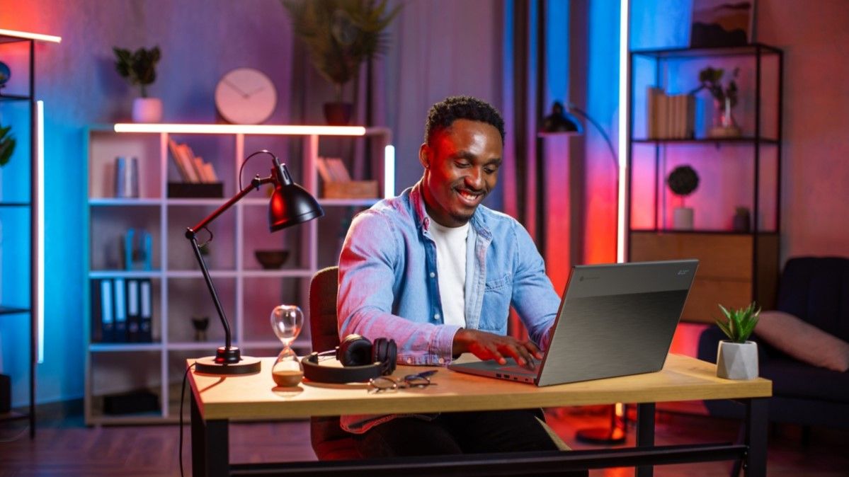 Man playing Acer Chromebook 516 GE on table