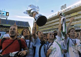 Banfield players celebrate with the trophy at Boca Juniors' La Bombonera stadium after winning the Argentine title in 2009.