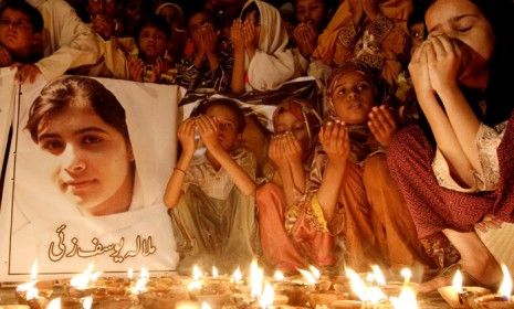 A group of Pakistani children pray for Malala Yousufzai (the 14-year-old girl who was shot by the Taliban) in Karachi, on Oct.12.