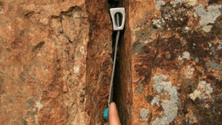 How to correctly place a climbing nut in a crack in a cliff for traditional protection in rock climbing