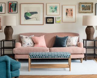 seating area with pink sofa and blue patterned footstool
