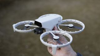 DJI Flip drone in the hand, propellors unfolded