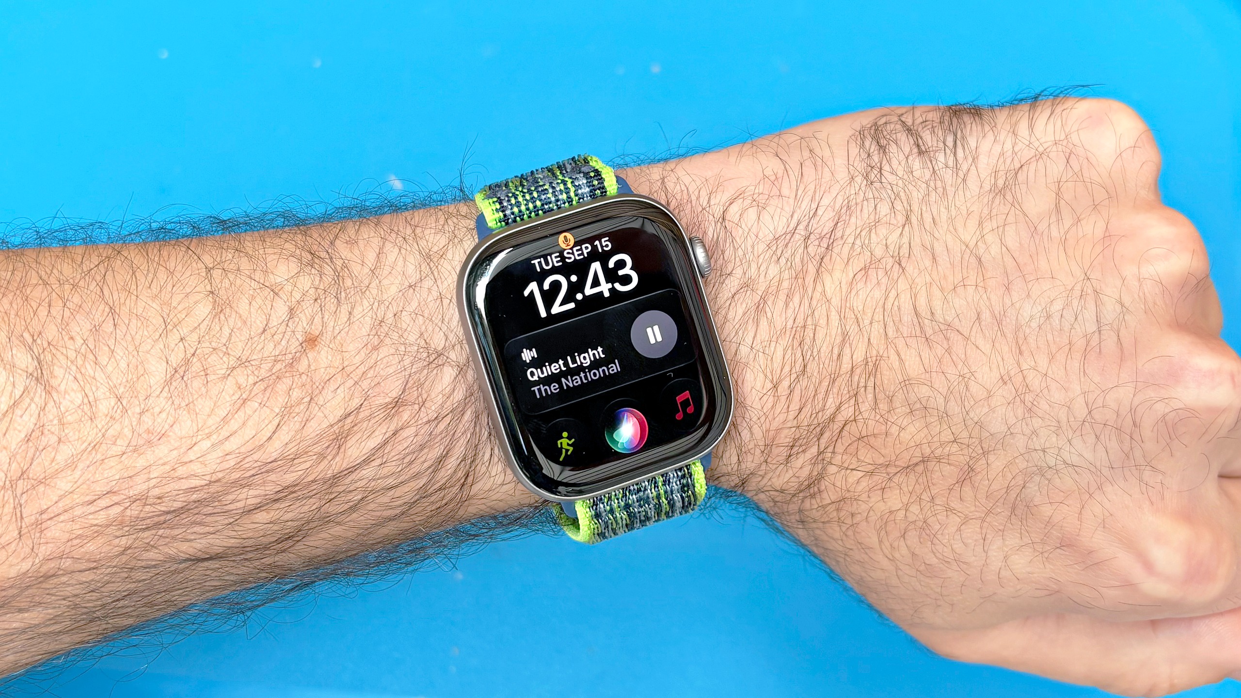 Close-up of the Siri AI setup process using an Apple Watch 11 and iPhone 16 Plus