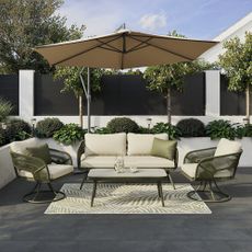 GoodHome Giza Green Metal 4 Seater Coffee set in garden on black decking with large parasol and green and white rug