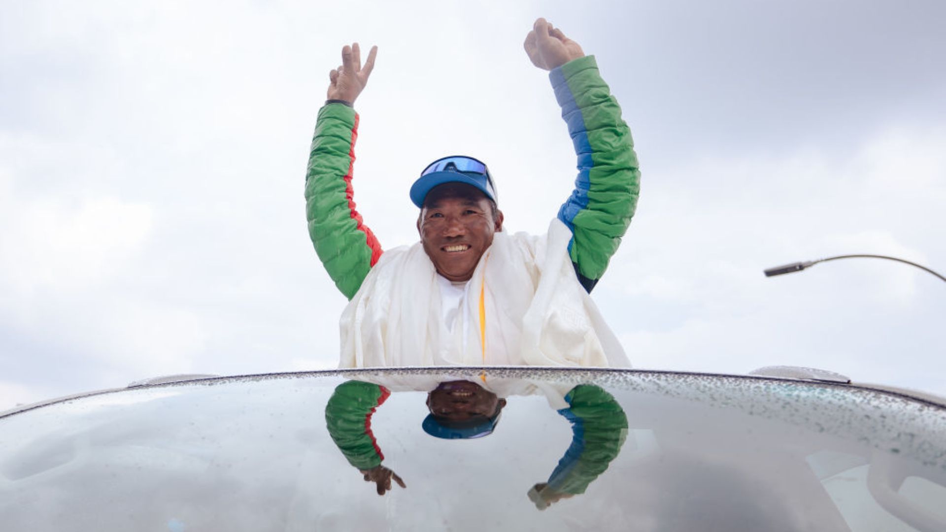 Kami Rita Sherpa waves at crowds after scaling Everest for the 30th time