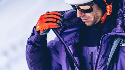 Man on snowy mountainside wearing The North Face Summit Series kit