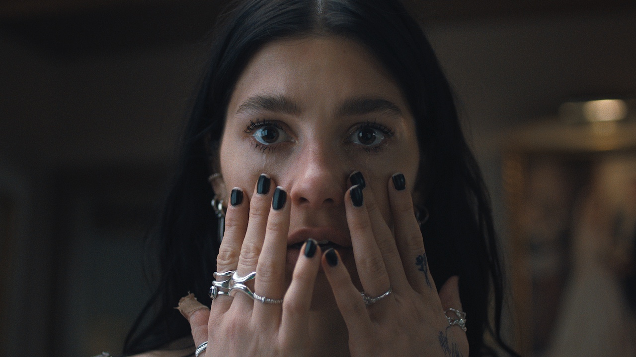 Camila Morrone crying with her hands on her face in Something Very Bad Is Going to Happen