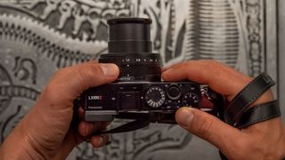 Photo of someone holding the Panasonic Lumix LX100 II taken from above