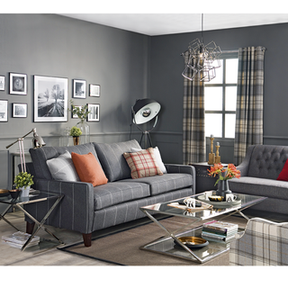 living room with grey wall and grey sofa