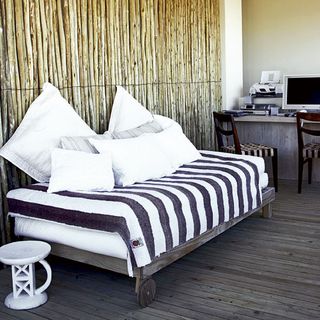 wooden wall with wooden flooring and bed