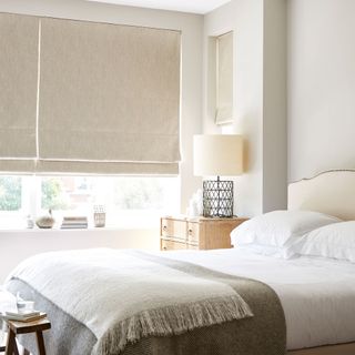 neutral blackout roman blinds in a bedroom