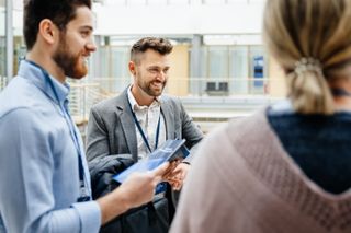 An image of business people looking at printed material