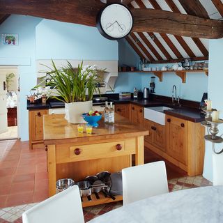 kitchen with blue walls and wooden worktop