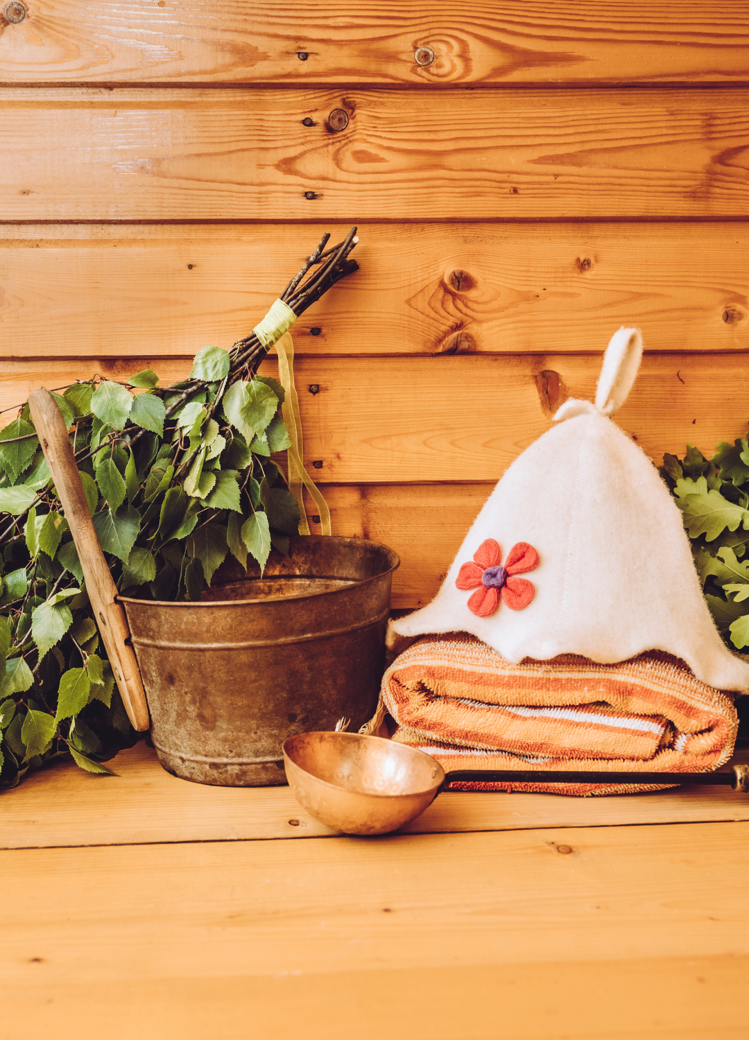 Sauna with a sauna hat and branches