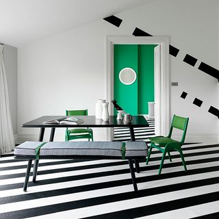 dinning room with dinning table white wall black and white striped flooring