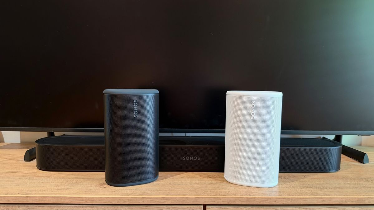 Sonos Beam Ultra with black and white Sonos Play speakers on a TV unit.