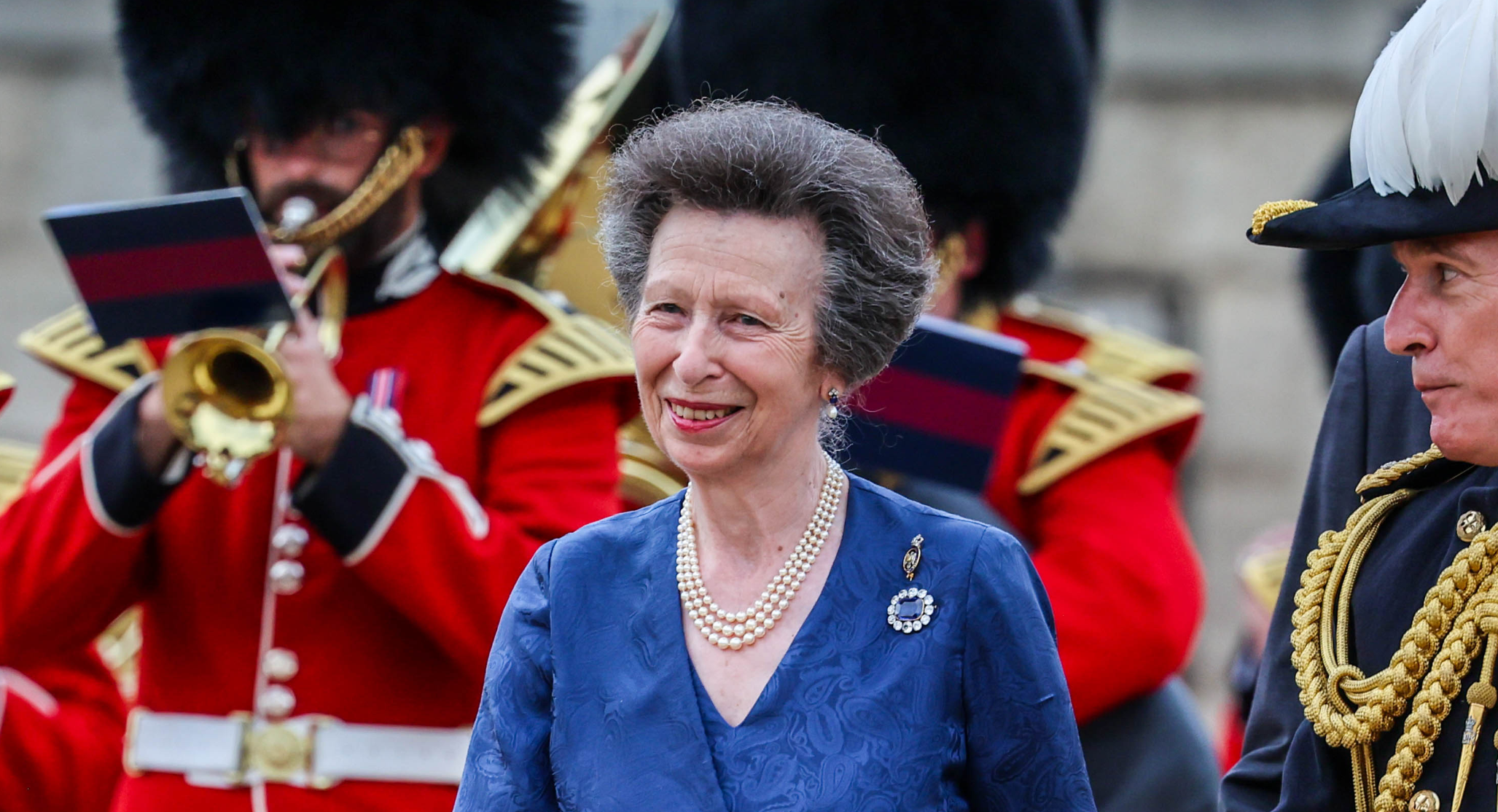 Princess Anne wears a pearl necklace and blue dress