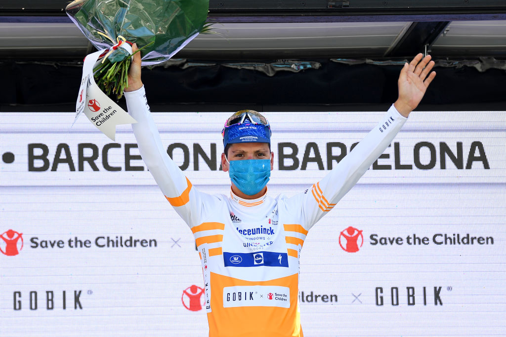 BARCELONA SPAIN  MARCH 28 Podium  Joo Almeida of Portugal and Team Deceuninck  QuickStep Yellow best young jersey Celebration during the 100th Volta Ciclista a Catalunya 2021 Stage 7 a 133km stage from Barcelona to Barcelona  Mask  Covid safety measures  Flowers  VoltaCatalunya100  on March 28 2021 in Barcelona Spain Photo by David RamosGetty Images