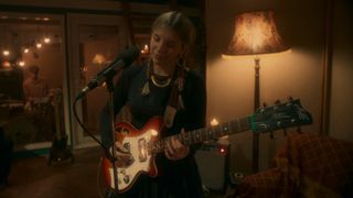 Maya Delilah plays a Maton electric guitar