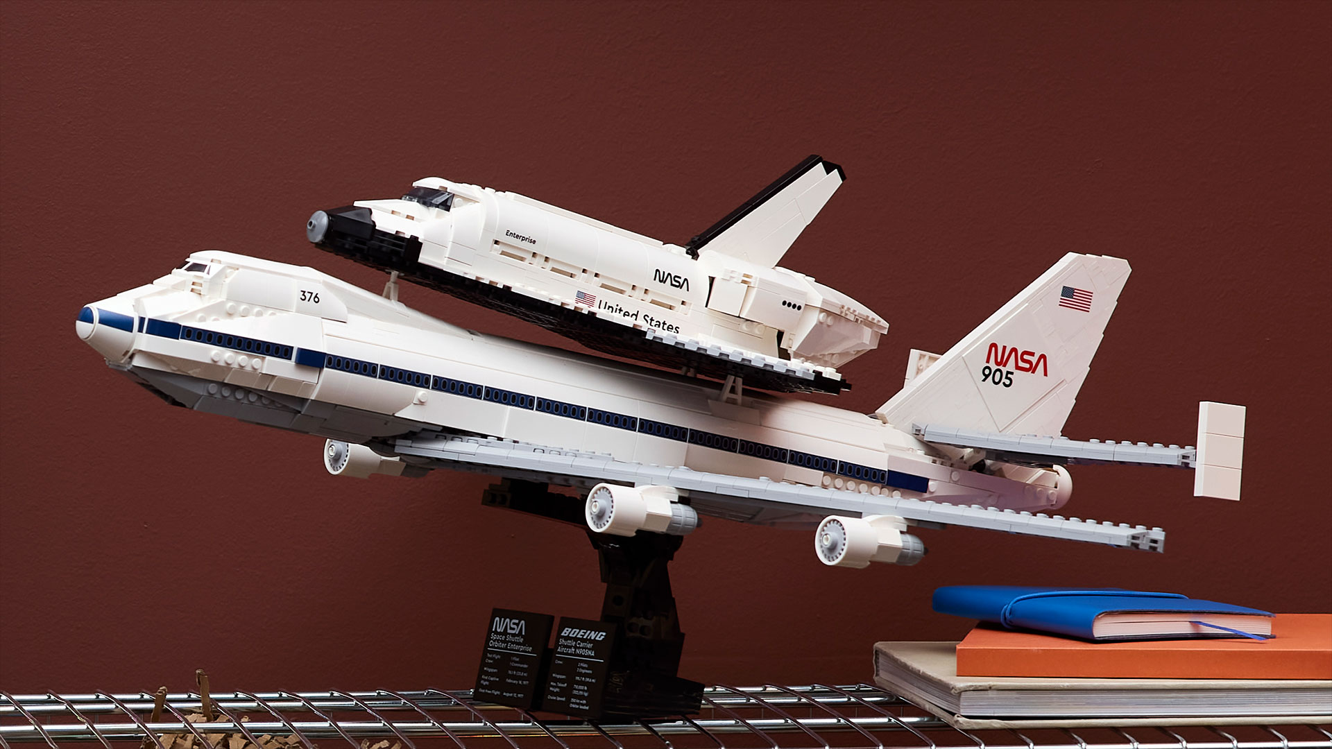 a toy brick built model of a jumbo jet carrying a winged spacecraft on its back