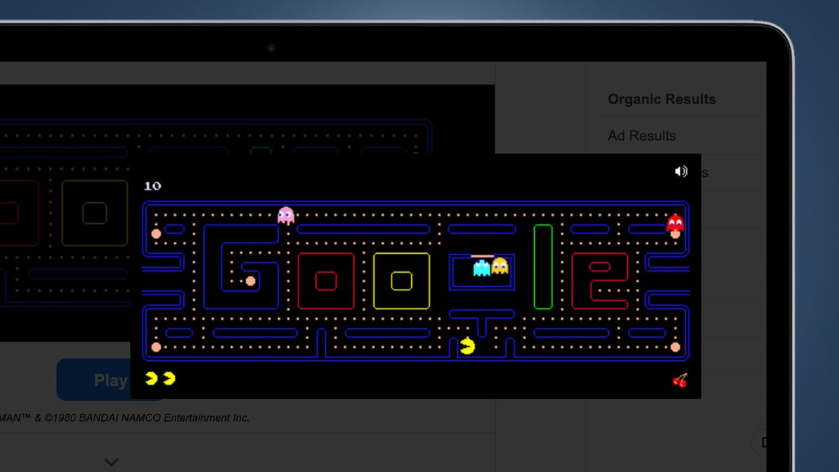 A laptop screen on a blue background showing Google's Pac-Man game